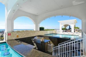 an indoor swimming pool with an outdoor kitchen and a swimming poolvisor at Emerald 705 in Galveston