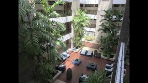 an overhead view of a building with a courtyard with palm trees at Apartamento Flat Ecosummer Tambaú in João Pessoa