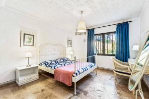 Postel nebo postele na pokoji v ubytování Villa Flores + 16 fotografií