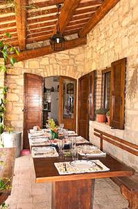 a dining room with a long table in a building at Villa I Camini - Outbuilding, dependance - Swimming pool - Garden - BBQ and fireplaces - Soccer field in Monte Castello di Vibio +51 photos