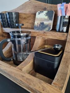 a wooden tray with a pot and a pan in it at Mien B&B in Murmerwoude