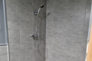 a shower with a glass door in a bathroom at Angelas Hideaway private hot tub and sauna in Dungannon