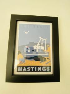 a picture of a boat in a picture frame on a wall at Castle View 2 Bedroom Apartment in Town Centre in Hastings