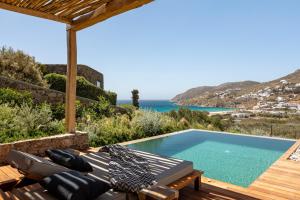 a villa with a pool and a view of the ocean at Mileo in Kalo Livadi