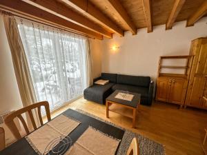 a living room with a couch and a table at Apartmán 339 - Tatralandia in Liptovský Mikuláš +48 photos