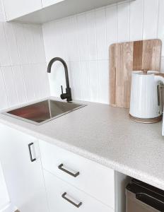 a kitchen with a sink and a counter top at The Hideaway - Guest House in Warrnambool
