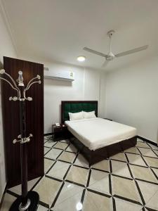 a bedroom with a bed and a ceiling fan at AFAQ AL BATINAH - SAHAM in Şaḩam +18 photos