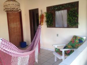 a room with two hammocks in a house at Pousada Mar e Sol in Pipa