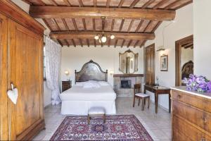 a bedroom with a white bed and a desk at Villa Sunshine in Gambassi Terme