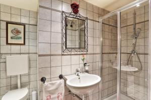a bathroom with a toilet and a sink and a shower at Villa Sunshine in Gambassi Terme +22 photos