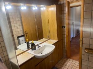 a bathroom with a sink and a mirror at Pescocostanzo chalet in Pescocostanzo