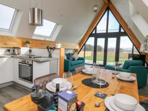 a kitchen and living room with a table and chairs at Elan Valley Welsh - The Sheepfold in Llandrindod Wells