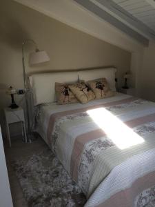 a bedroom with a bed and a lamp at Villa Vignolo in Stresa