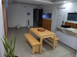 a small wooden table and bench in a room at Pull Up in Praia