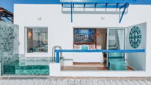 a view of a house with a blue table at Sollaris Ecopousada in Japaratinga