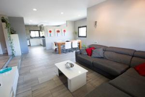 a living room with a couch and a table at Catalunya Casas Modern Marvel,15 min to Costa Brava beaches! in Sils