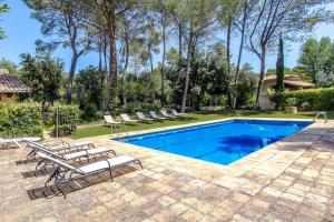 a swimming pool with lounge chairs next to a house at Catalunya Casas Heavenly Haven for 16 pax , 30km from Barcelona! in San Felíu del Racó