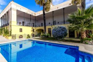 een huis met een zwembad voor een gebouw bij Catalunya Casas Impressive and Idyllic mansion for up to 40 people! in Banyeres del Penedes