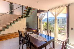 a dining room with a table and a staircase at Catalunya Casas Stunning modern villa and just half hour to Barcelona! in Caldes de Montbui