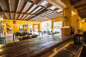 a large wooden bar in a restaurant with tables and chairs at Catalunya Casas Relax and Recharge - only 34km from Barcelona! in Rubí
