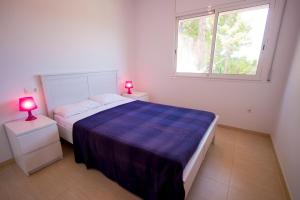 A bed or beds in a room at Catalunya Casas Fun and Frolic in Lloret del Mar 3500 meters to beach!