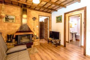 a living room with a fireplace and a television at Catalunya Casas Costa Brava villa with private pool & spacious garden in Santa Coloma de Farners