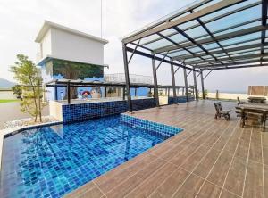 a house with a swimming pool and a patio at Starlight Homestay The Venus Sitiawan in Seri Manjung