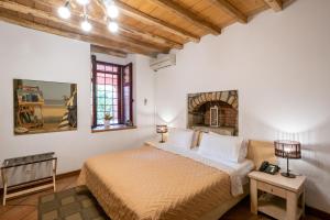 a bedroom with a large bed with a fireplace at The Varos Residences Hotel in Város