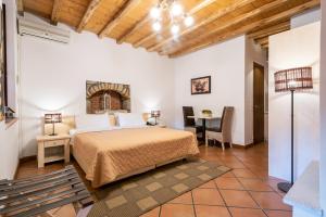 a bedroom with a bed and a table in a room at The Varos Residences Hotel in Város