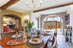 a dining room with a table with food on it at Villa Sunshine in Gambassi Terme
