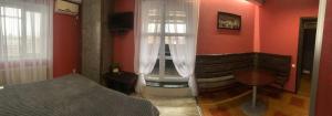 um quarto com uma cama e uma janela em Na Bukovinskoy Guest House em Kharkov