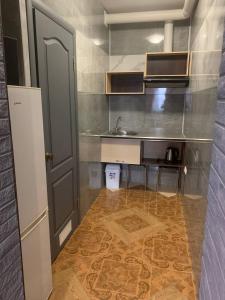 a small kitchen with a sink and a counter at Na Bukovinskoy Guest House in Kharkiv