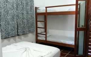 a room with two bunk beds and a mirror at Royal-inn SPA & Pousada in Itanhaém