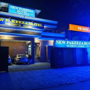 a car parked outside of a new kaiser hotel at night at New Pakeeza Hotel in Lahore