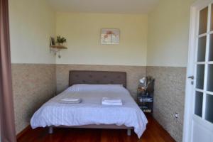 a bedroom with a bed with two towels on it at Amoureux du calme et de la nature in Tanneron