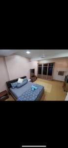 a bedroom with a blue bed in a room at A Spacious 3BR 2storey House Taman Kosas Ampang in Ampang