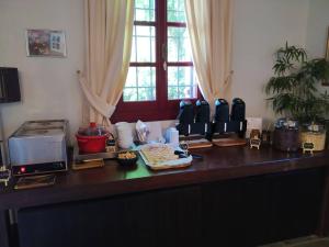 a kitchen counter with a table with food on it at The Varos Residences Hotel in Város