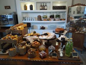 a bakery filled with lots of different types of pastries at The Varos Residences Hotel in Város