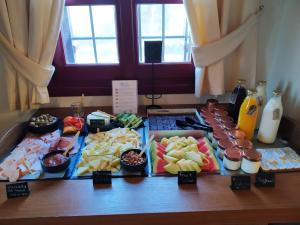 a table with a bunch of different types of food at The Varos Residences Hotel in Város