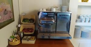 a kitchen mixer sitting on a counter with plates at The Varos Residences Hotel in Város