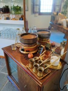 a table with two pots and pans on top of it at The Varos Residences Hotel in Város