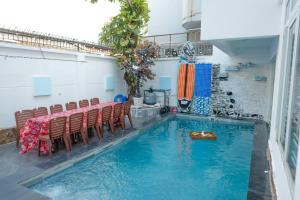 a pool with chairs and a table in a room at S1 VILLA - SunHill Villa in Vung Tau