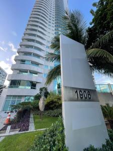 a sign in front of a tall building at 202 Flat Beira Mar Av Boa Viagem in Recife