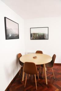 a table and chairs in a room with white walls at Apartamento La Campa in Canfranc-Estación