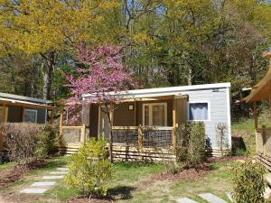 a tiny house in the woods with a tree at Nantes Camping Le Petit Port in Nantes