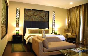 a hotel room with a bed and a couch at Vivanta Dal View in Srinagar