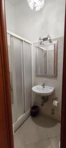 a bathroom with a sink and a shower and a mirror at In Rome in Rome