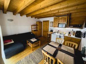 a living room with a dining table and a kitchen at Apartmán 339 - Tatralandia in Liptovský Mikuláš