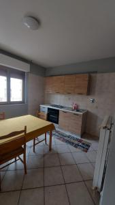 a kitchen with a table and a kitchen with a stove at Villesse Appartamenti 