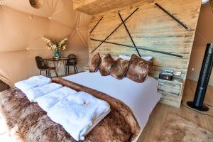 a bedroom with a large bed with a wooden wall at Finest Retreats - Scotney Luxury Dome 